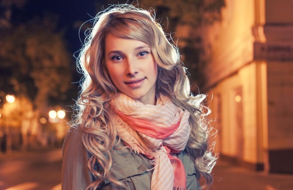 Portrait of a young female businesswoman in night city. Close-up, shallow DOF.